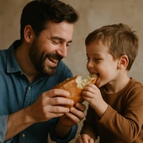 father and son sharing bread